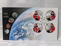 Front image showing Earth from space with six astronaut portrait stamps and commemorative design