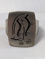 Front view of the rectangular pewter George Jensen ring showing abstract etched design on a lightly tarnished matte surface.