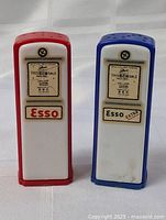 Front view of vintage Esso gas pump salt and pepper shakers showing branding and gas sale label detail