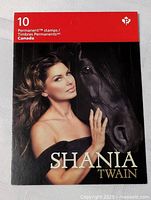 Front cover of Shania Twain Canada Permanent™ stamp book with photographic image of Shania Twain and black horse, showing title and stamp count.