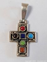Front view of the silver cross pendant with jeweled stones showing all detailed colors.
