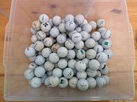 Plastic container filled with approximately 105 used white golf balls from various brands such as Callaway, Titleist, and Pinnacle.