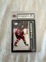 Front view of the Dawson Mercer Young Guns rookie hockey card in protective graded slab showing player's image and grading label.