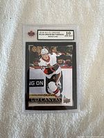 Front view of a graded 2018-19 UD Canvas Young Guns Drake Batherson rookie card showing Gem Mint 10 grade by KSA.