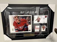 Front view of framed signed photo of Guy Lafleur with memorabilia and jersey number #10