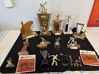 Overview of all vintage trophies and two boxed antiques on black cloth