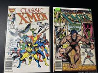 Photo showing two 1980s Classic X-Men comic books in protective sleeves: one with team cover and one featuring Wolverine.