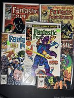 All 5 comic books arranged together showing full covers.