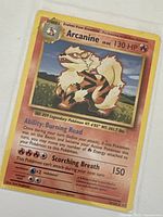 Front view of Arcanine Pokémon card showing artwork, HP, ability, attack, and card details.