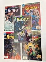 Five Batman comic books arranged side by side showing full covers, a mix of Detective Comics and Batman titles under Knightfall branding featuring Bane and other characters