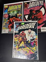 Photo showing all three Daredevil comics together, each in a protective plastic sleeve. Covers feature Daredevil and Kingpin prominently.
