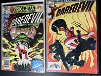 Photo of two Daredevil comic books, one showing Daredevil fighting a large green monster, and the other issue #194 showing Daredevil fighting ninjas.