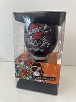 Packaged view of the black glass chalice with rhinestone skull and heart design showing branding and packaging details.
