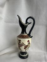 Front profile of the Greek pottery vase showing warrior figures and Greek key pattern near the neck.