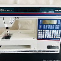 Front view of Lily 545 machine showing branding, LCD panel and sewing area