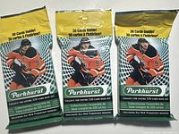Front view of three unopened 2019-20 Parkhurst NHL hockey card packs. Each pack states contains 30 cards and features an NHL player in Oilers uniform.