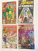 Four vintage Avengers comic books showing colorful front covers with superheros and comic titles.