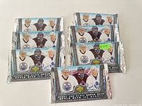 Front view of eight sealed 2007-2008 Upper Deck Heroes NHL hockey card packs showing player images and logos.