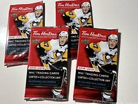 Front view of four unopened Tim Hortons 2018-2019 NHL trading cards packs showing Sidney Crosby in Penguins uniform