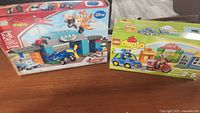 Photo shows two LEGO Duplo sets in original boxes: Disney Planes Airport set and My First Police set