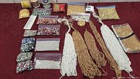 Overview of bead lot with various strands and bags of beads in different colors and sizes