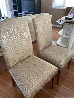 Two chairs front view showing upholstery pattern and seat condition