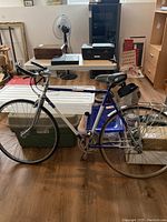 Full side view of men's 10-speed bike showing frame colors, tires, accessory bag, and positioning.