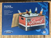 Packaging box showing product image of wooden crate cooler filled with ice and bottles, Ford Mustang logo on front, bottle opener on side, removable liner and lid.