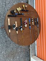 Overhead view of ten ice fishing rods on round table