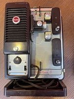 Top view of Kodak Super Showtime 8 projector showing control knobs, power cord, and branding on body