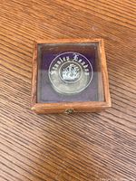 Top view of the wooden presentation box with glass lid showing Stanley London logo and emblem.