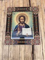 Front view of the framed icon showing Jesus and ornate geometric painted frame