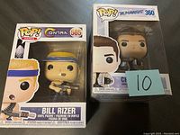 Photo of two Funko POP vinyl figures in boxes: Bill Rizer from Contra and Chase Stein from Runaways.
