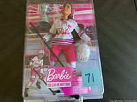 Front view of unopened Barbie You Can Be Anything Ice Hockey Player doll with accessories in packaging