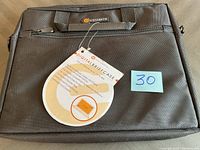 Front view of the new Iconcepts digital briefcase in black fabric with tag and zipper pocket visible.