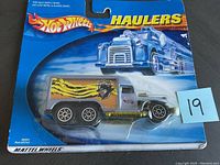 First Hot Wheels Haulers toy truck still sealed in original blue packaging with tiger stripe and panther graphics on the cargo section.
