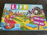 Front view of unopened The Game of Life board game box showing colorful artwork and branding.
