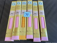 Six unopened vinyl paper rolls, five pink and one orange, in original yellow packaging with CS branding.