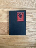 Front cover of the antique book 'Cyclops' Eye' showing black hardcover with a red illustrated label