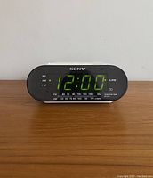 Front view of clock radio with digital time display showing 12:00