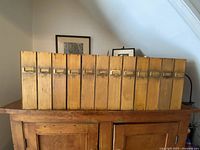 Front view of all twelve wooden file boxes aligned showing brass name plates