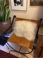 Full view of sheepskin pillow on chair showing size and color