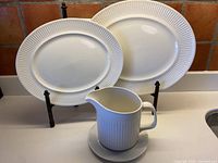 Full view of two oval platters, gravy boat and saucer