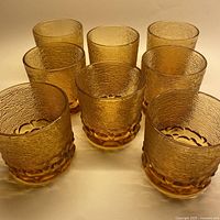 All eight amber textured lowball glasses arranged in rows