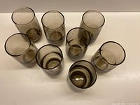 Top view of eight smoky brown tumblers arranged on surface