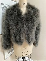 Front view of grey feather cropped jacket on mannequin