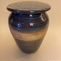 Front view of stoneware lidded vessel