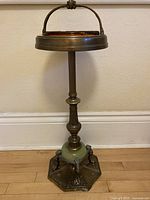 Full view of brass ashtray stand showing overall form