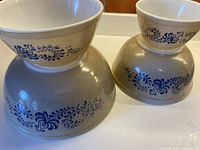 Four Pyrex Homestead bowls, two inverted showing exterior motif