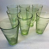 Front group view of eight pale lime green tumblers showing form and color